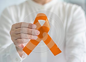 Orange ribbon for awareness on Leukemia, Kidney cancer, RDS disease, multiple sclerosis, ADHD illness, COPD photo