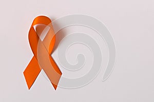 Orange ribbon on white background . Healthcare and medicine concept. Multiple Sclerosis awareness. Leukemia awareness. Empty text