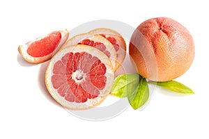 Orange ripe grapefruit whole and sliced with leaves on a white background.
