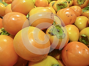 Orange ripe kaki fruit in the market
