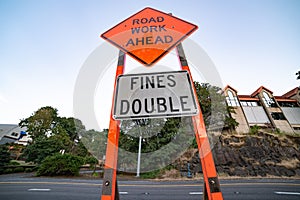 Orange road construction sign on the street