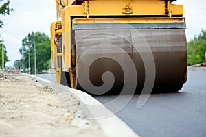 Orange road-roller on repairing of the road