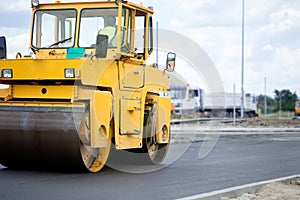 Orange road-roller on repairing of the road