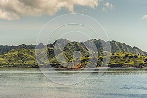 Orange rock lights up Rinca Island westside coast, Indonesia photo