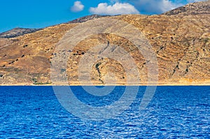 Orange rocky hill and deep blue ocean