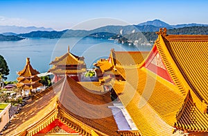 Orange roof of the Wen Wu Temple with Sun Moon Lake in the bachground