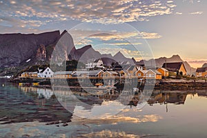 Orange rorbu houses at sunset