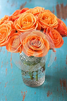 Orange rose flowers in vase photo