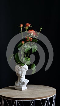 Orange rose flowers in a vase sculpture of David