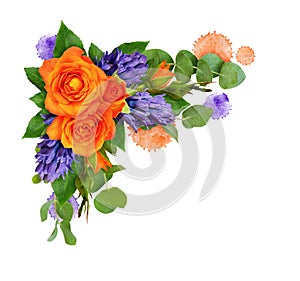 Orange roses and hyacinth flowers with eucalyptus leaves and paint blots in a corner floral arrangement