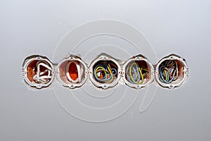 Orange, round installation box mounted in a white wall with an extension installed.