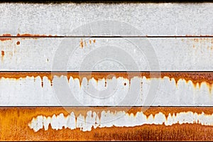 Orange rust patterns on a galvanised steel metal surface