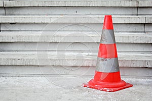 Orange safety pylon on stairs