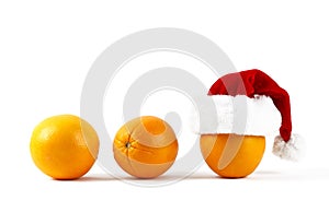 Orange in Santa hat. Christmas or New Year concept with oranges