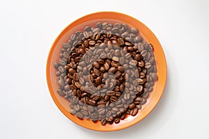 Orange saucer with coffee beans on white table