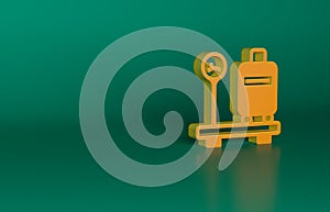 Orange Scale with suitcase icon isolated on green background. Logistic and delivery. Weight of delivery package on a