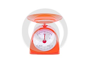 Orange scales weighing products on white background kitchen equipment object isolated