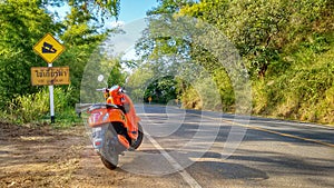 Orange scooter motorbike at the street in Thailand