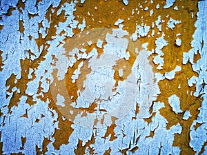 Orange sheetmetal with flaking white paint over it