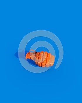 Orange shiny grenade conflict concept weapon sunlight gen z blue background