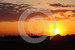 Orange silhouette prairie Saskatchewan sunset
