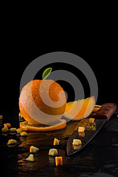 Orange on slate stone with dark background.