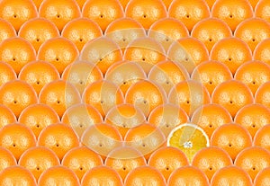 Orange slice amongst many whole orange's can be used as a backgr