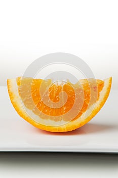 Orange Slice Closeup on White Plate