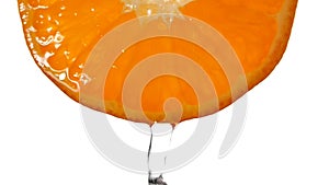 Orange slice juice water splashing in slow motion on white background