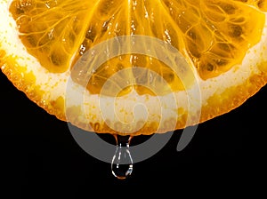 An orange, sliced and dripping with juice, indicates juiciness. Orange juice dripping from orange fruit. studio shot fruit with