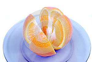 Orange slices. Cut into 4 parts orange, lying on a plate on a white background.