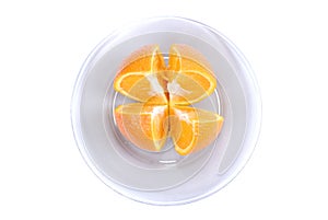 Orange slices. Cut into 4 parts orange, lying on a plate on a white background.