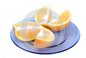 Orange slices. Cut into 4 parts orange, lying on a plate on a white background.