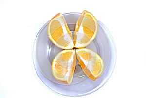 Orange slices. Cut into 4 parts orange, lying on a plate on a white background.