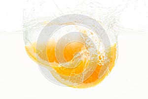 Orange Slices falling deeply under water with a big splash