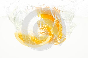 Orange Slices falling deeply under water with a big splash