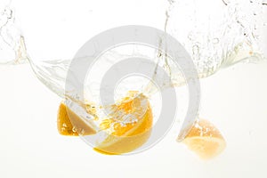 Orange Slices falling deeply under water with a big splash