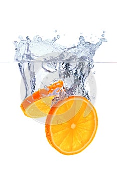 Orange slices falling into the water