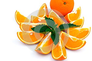 Orange with slices and green leaves of mint on white background