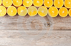 Orange slices on wooden background with copyspace
