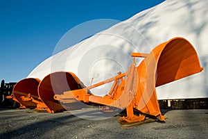 Orange snow plow blades