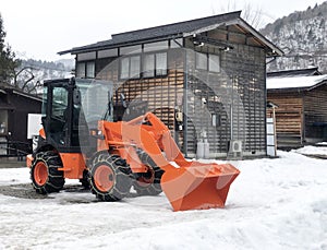 Orange Snowplow Truck Remove the Snow in Shirakawago, Japan
