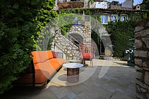 Orange sofa and tables outdoor in Eze