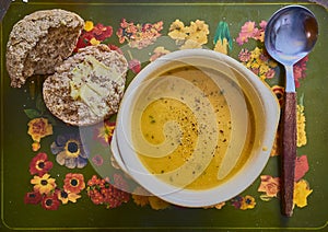 Orange soup and a rustic wholemeal bread roll