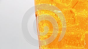 Orange sparkling water with Ice in glass.