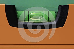 Orange spirit level with green bubble