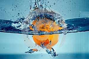 Orange splashing into the water