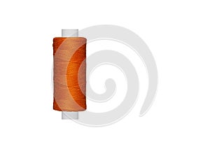orange spool of sewing thread isolated on white background