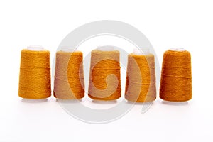 Orange spool of thread isolated on white background. Skein of woolen threads. Yarn for knitting. Materials for sewing
