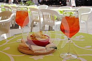 orange spritz with aperol, aperitiv with septuplets, small canapÃ©s to go with the drink, small tramezzini and crisps